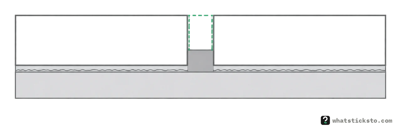 Cut-away of two tiles with the old grout between them dug out partway down, leaving firm grout at the bottom of the joint.